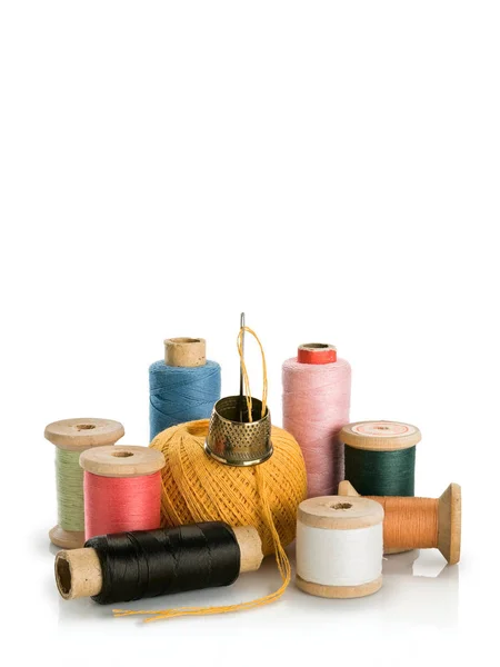 Group of old coils with multi-colored threads and needle with th — Stock Photo, Image