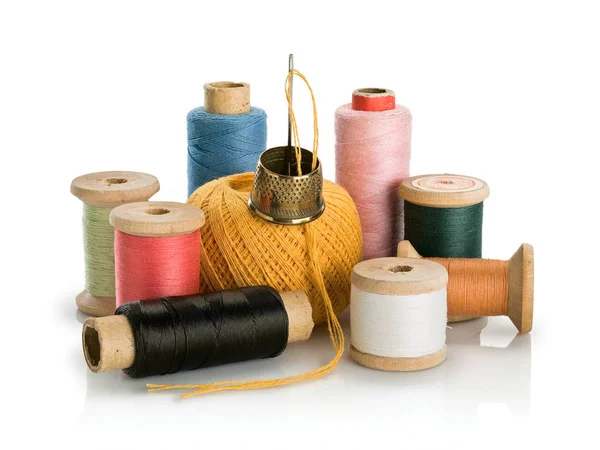 Group of old coils with multi-colored threads and needle with th — Stock Photo, Image