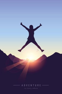 happy girl with raised arms jumps at purple mountain landscape