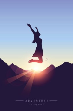 happy girl with raised arms jumps at purple mountain landscape