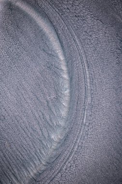 Dramatik siyah, tek renkli soyutlama, ejderha pullarını ya da kek lavlarını anımsatıyor, koyu gri, gümüş ve bronz aksanlarla parıldıyor. Alkolik mürekkep birbirine karışıyor. Modern bir sanat eserinin parçası..