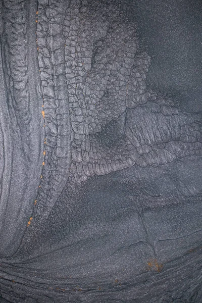 Dramatik siyah, tek renkli soyutlama, ejderha pullarını ya da kek lavlarını anımsatıyor, koyu gri, gümüş ve bronz aksanlarla parıldıyor. Alkolik mürekkep birbirine karışıyor. Modern bir sanat eserinin parçası..