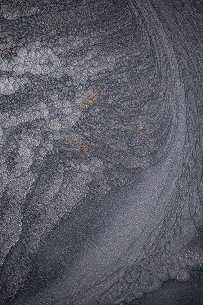 Dramatik siyah, tek renkli soyutlama, ejderha pullarını ya da kek lavlarını anımsatıyor, koyu gri, gümüş ve bronz aksanlarla parıldıyor. Alkolik mürekkep birbirine karışıyor. Modern bir sanat eserinin parçası..