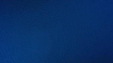 Water circle spinning and spreading motion surface in blue shade.