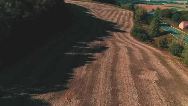 Concept of harvesting. Empty plowed field with dark soil at beginning of spring or end of autumn. — ストック動画