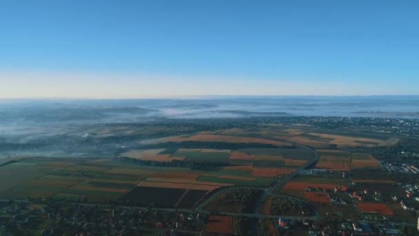 Drone aerial smooth flying view of village countryside in mist. — Stock video