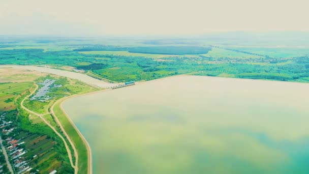 Okyanustan yükselen dağlar berrak sessiz suyla mavi gökyüzü altında kabarık beyaz bulutlarla. — Stok video