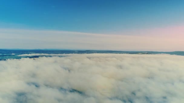 Vue panoramique épique du brouillard de surface mouvant rayonné de rayons de soleil couvrant un continent. Paysage de ciel débordée . — Video
