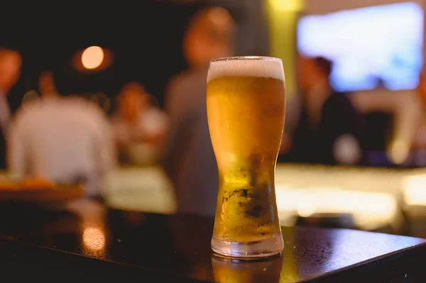 Glass of beer placed casting a shadow on the sky bar counter in restaurant. Cold beer, perfect for hang out after work. Beer, hang out, relax, restaurant, dinner concept.