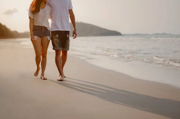 Romantic couple walking holding hands each other while at beach at sunrise, plan life insurance at future concept. copy space for text. couple, love, beach, romantic, summer, lifestyle concept.