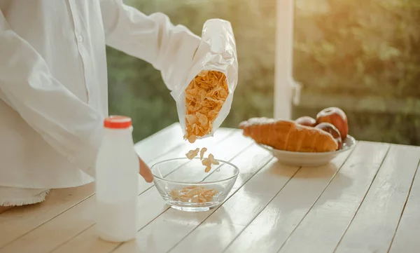 Young woman asia wake up refreshed in the morning and relaxing eat coffee, cornflakes, bread and apple for breakfast at house on holiday. Asian, asia, relax, breakfast, refresh, lifestyle concept.