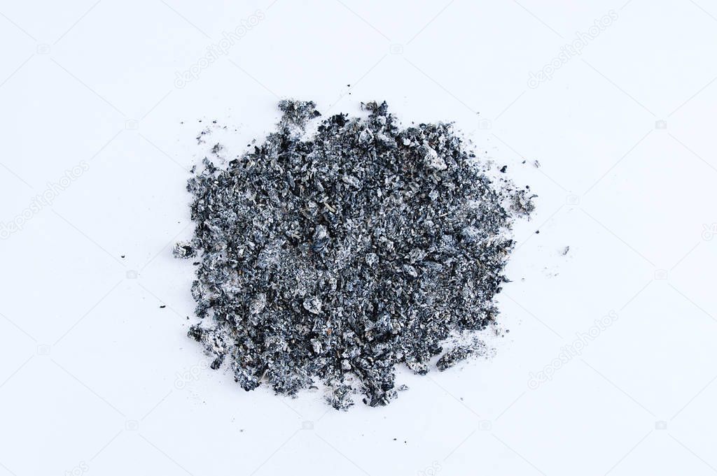 Pile of tobacco ash on a white background. View from above.