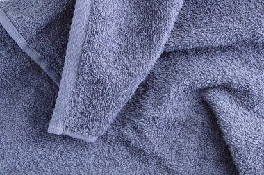 Texture of a gray terry towel with a edged edge closeup. Home textiles.