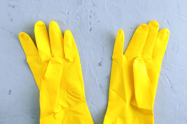 Yellow Protective Rubber Gloves Gray Concrete Background — Stockfoto