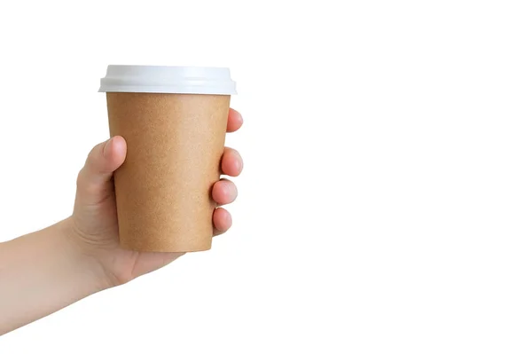 Paper brown cup of coffee in the hand of a caucasian girl. White isolate.