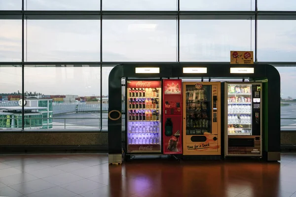 Porto, October 2019 - Drinks, snacks and chocolates vending machine in airport overlooking the landing strip — Stock Photo, Image