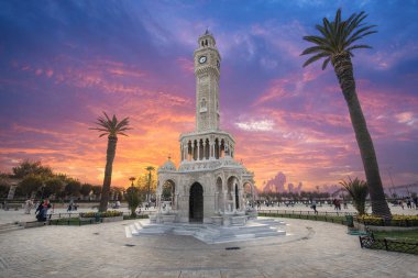Konak Square street view with old clock tower (Saat Kulesi) at sunset. It was built in 1901 and accepted as the official symbol of Izmir City, Turkey.  clipart