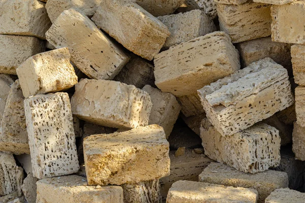 Yellow crimean sawn limestone prepared for construction of building. Traditional porous heat-insulating stone for walls, hedges and construction. Natural material known since antiquity