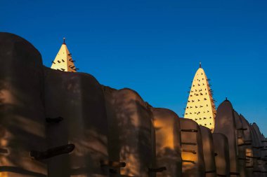 Walls and towers of the Mosque of Bobo-Dioulasso building exterior at sunset, landmark of Burkina Faso, West Africa. clipart