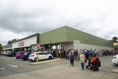 Perth, Australia - March 15, 2020: People queuing at Coles grocery store during the Coronavirus crisis clipart