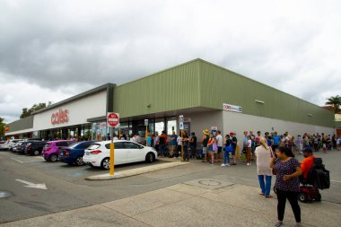 Perth, Australia - March 15, 2020: People queuing at Coles grocery store during the Coronavirus crisis clipart