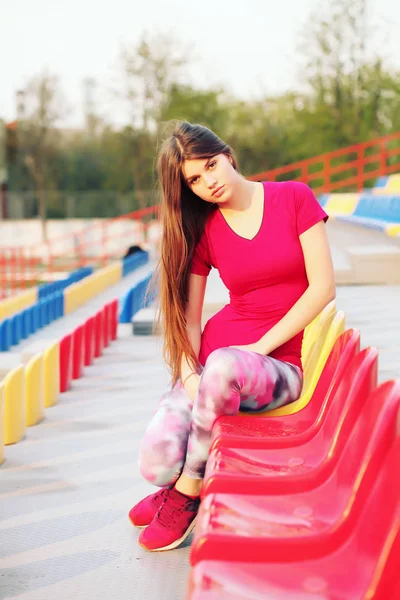 Beautiful smiling female football supporter watching football game — Stock Photo, Image