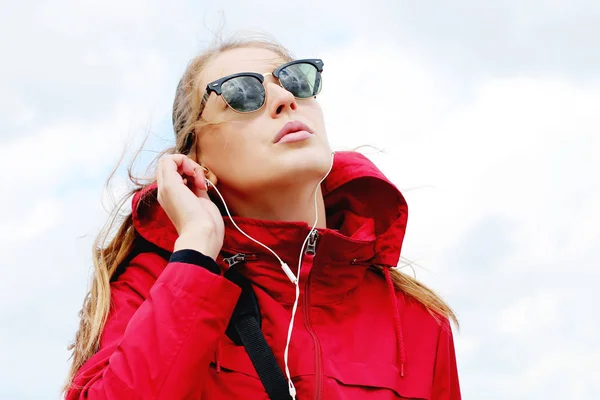 Atractiva mujer escuchando música en auriculares —  Fotos de Stock
