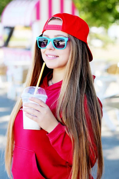 Attractive young woman in red cap — Stock Photo, Image