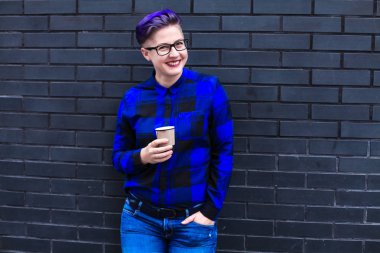 Mavi Flannel Giyen Kadın Kara Duvara Karşı Kağıt Kupa Tutuyor