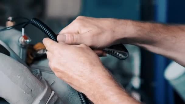 A close up of a hand mending the engine — Stock Video