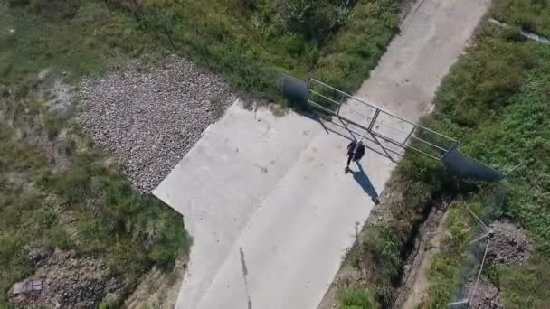 Un hombre caminando por una acera — Vídeos de Stock