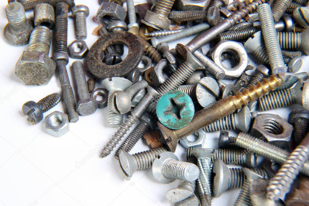 A lot of screws and nuts on a white background