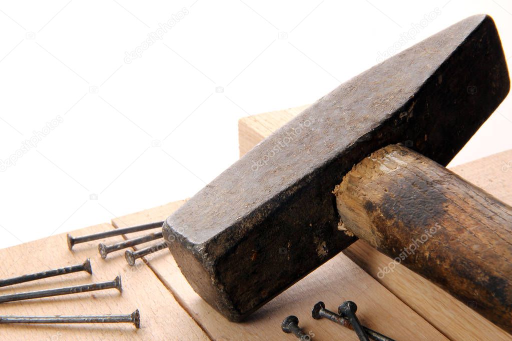 hammer and nails on wooden board in studio