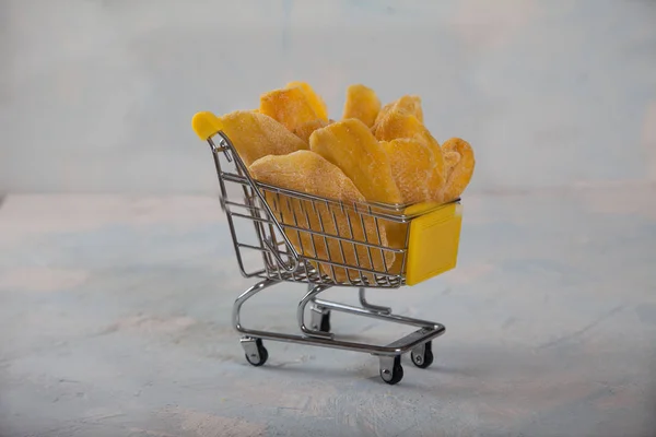 Přírodní mango chipsy v nákupním košíku. Vodorovně — Stock fotografie