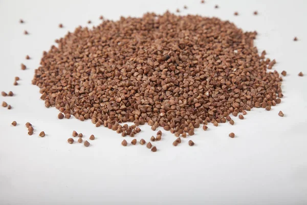 Buckwheat seeds closeup isolated on white background. Top view. — Stock Photo, Image