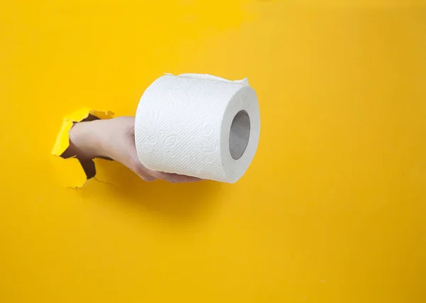 Female Hand Holds Roll Toilet Paper Yellow Background Hand Hole — Stock Photo, Image
