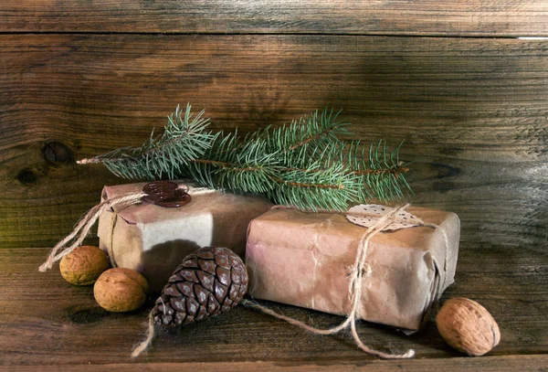 Xmas gifts wrapped in rustic paper — Stock Photo, Image