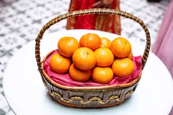 Group of orange put in woven basket ,on desk,fresh fruit,sign and symbol of good luck ,Chinese tradition.