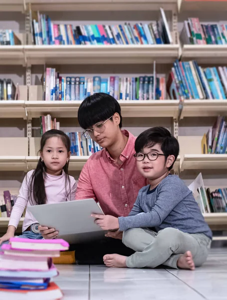 Két Kisgyerek Megtanulja Használni Laptopot Tanárral Könyvtárban — Stock Fotó