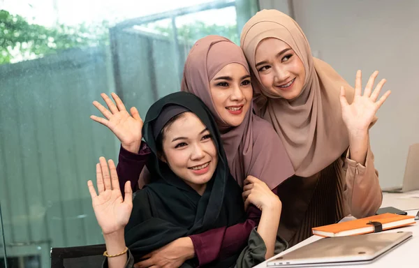 Three muslim women working at office together,with happy feeling,good friendship,teamwork