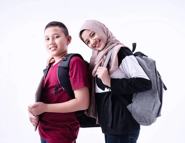 Two muslim students standing together,on white backgound,with smile and happy feeling