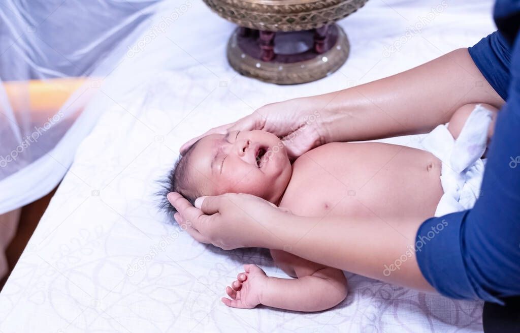The therapist massaging on body of newborn baby,for relaxing and therapy program
