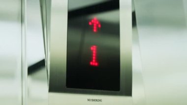 Interior of steel silver elevator which rises up inside of modern business center. Digital display in the elevator showing floor number. Lift go up to eleven floor. Cabin of modern passenger elevator