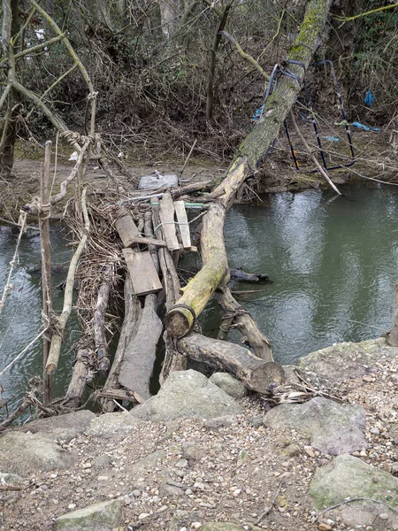 Sucio puente viejo en un río hecho de escombros — Foto de Stock