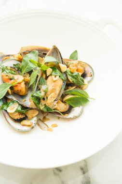 Kızarmış midye fesleğen yaprakları ile