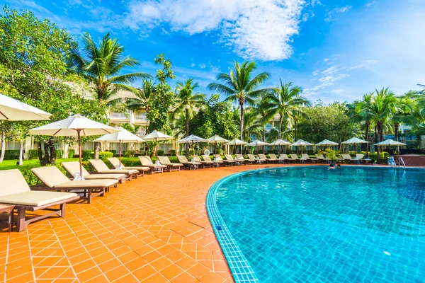 Paraguas y silla alrededor de la piscina — Foto de Stock