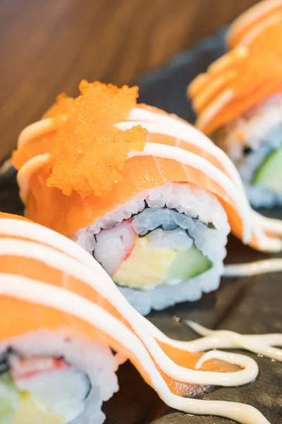 Salmon sushi roll with sauce — Stock Photo, Image
