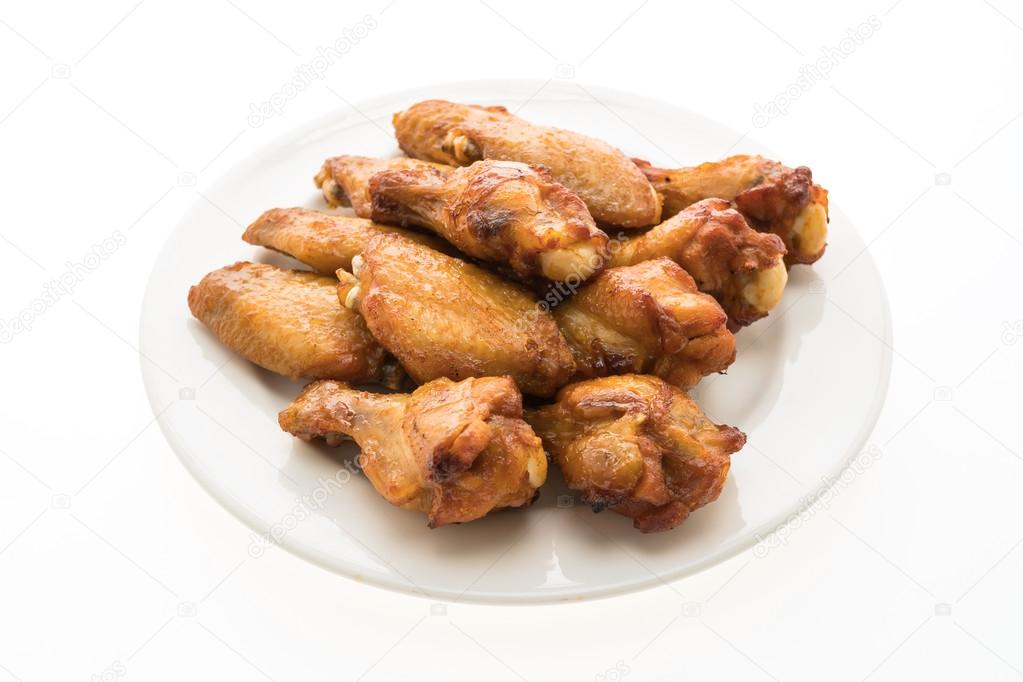 Grilled chicken wings on white plate