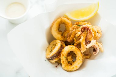 Kızarmış kalamar yüzük limon ve sos ile 