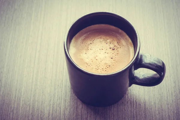 Café con leche en taza negra —  Fotos de Stock